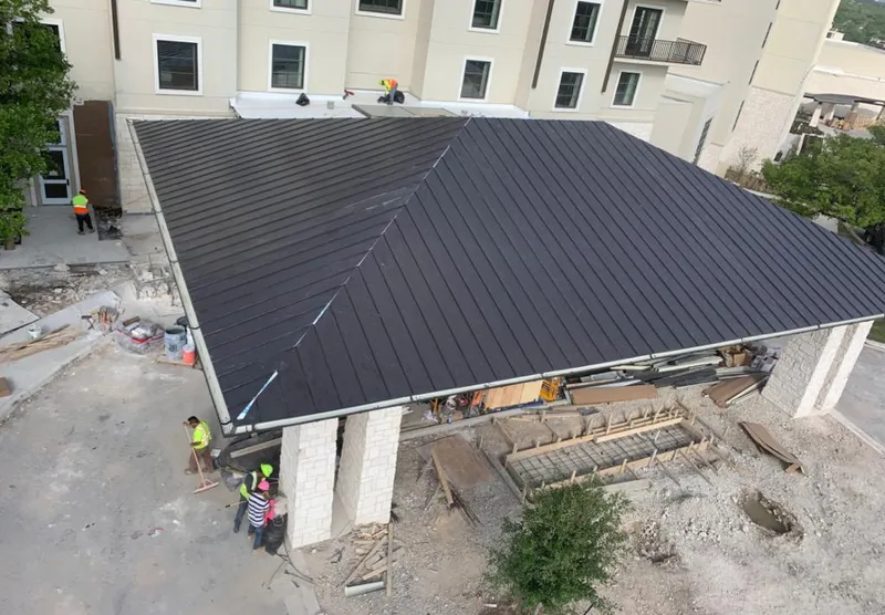 Metal roofing installation team working on a commercial building in Beebe